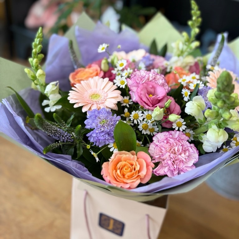 Florist choice seasonal hand tied in aqua pack
