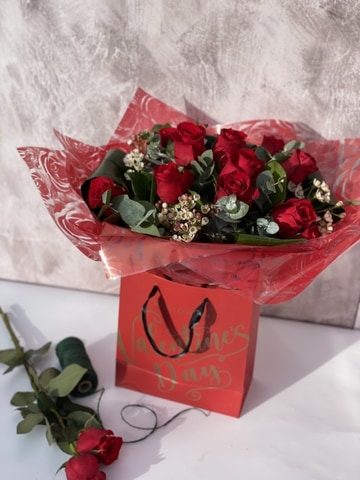 12 red roses in bag