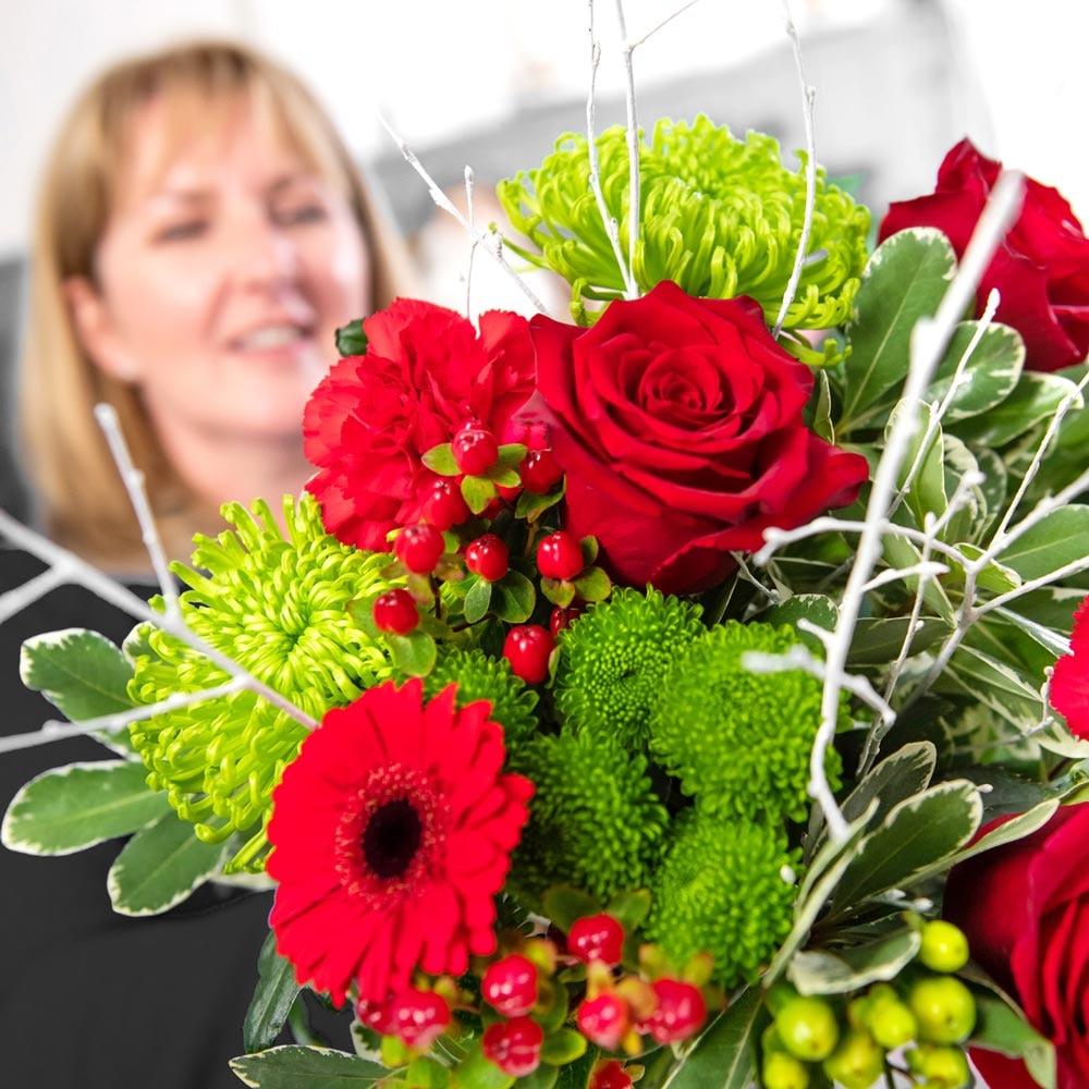 Christmas florist choice gift-wrap of fresh festive blooms in red and green wrap of fresh festive blooms in red and green wrap of fresh festive blooms in red and green wrap of fresh festive blooms in red and green wrap of fresh festive blooms in red and g