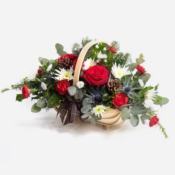 Basket of joy with seasonal flowers and festive foliage