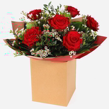 Six roses of romance bouquet with red roses and white filler in kraft gift box