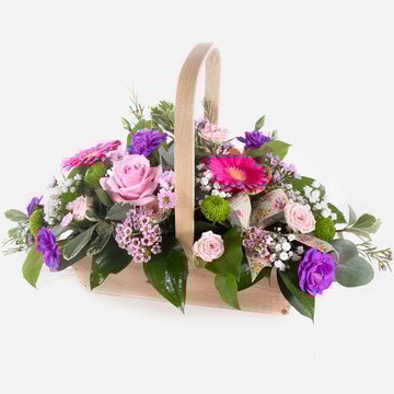 Bon bon pastel flower basket with roses gerberas and seasonal blooms
