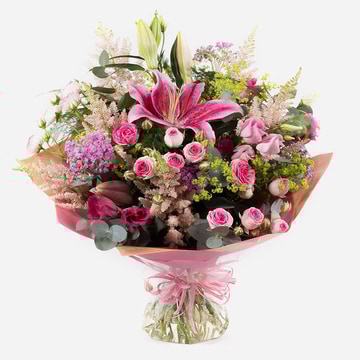 Out of this world hand tied bouquet with pink lilies roses and seasonal blooms