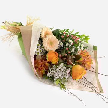 Peaches cream bouquet with orange peach and white flowers wrapped in eco friendly paper