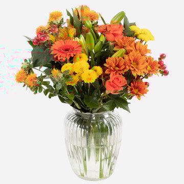 Orange sky vibrant autumn vase with yellow and orange blooms