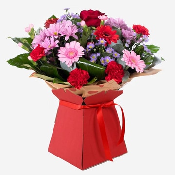 Mrs kisses romantic hand tied bouquet in a red gift box with pink and red flowers including a single red rose