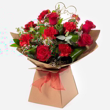 Smooch romantic bouquet of red roses and red carnations in a gift bag