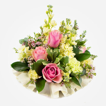 Small funeral posy in pink and cream with roses and delicate foliage