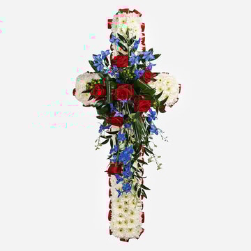 White funeral cross with red roses and blue delphinium spray on a 120cm frame