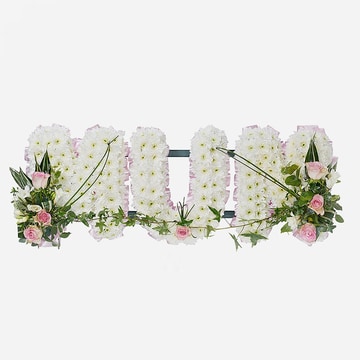 Mum funeral tribute in white chrysanthemum letters on a grey background