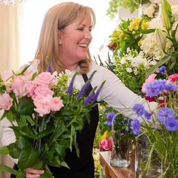 Florist selecting fresh seasonal flowers in shop for a mothers day hand-tied bouquet florist selecting fresh seasonal flowers in shop for a mothers day hand tied bouquet 2