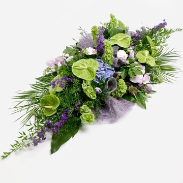 Modern arrangement of green anthuriums and lilac blooms