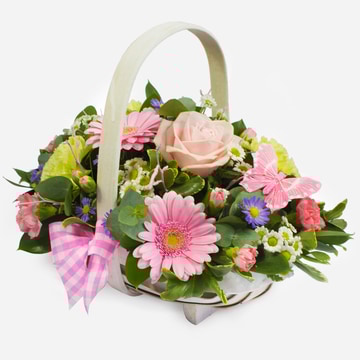 Pastel basket arrangement with pink roses germini and green carnations