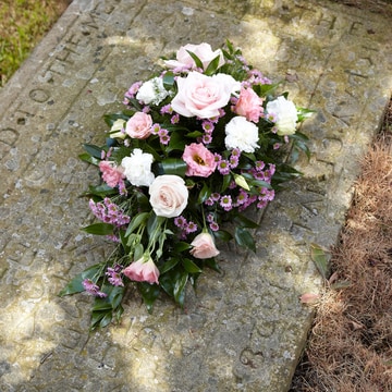 Petite funeral spray in pink with roses and lisianthus