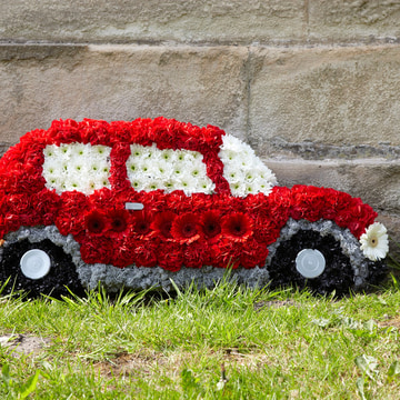 Motor car tribute with red carnations and white chrysanthemums