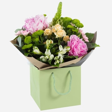 Delicate touch elegant bouquet of pink peonies and white roses with green foliage