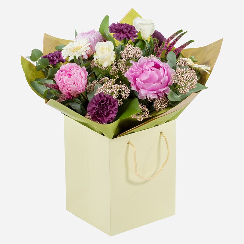 country-whispers-a-hand-tied-bouquet-with-pink-and-white-peonies-roses-and-seasonal-blooms-in-a-cream-gift-bag-1