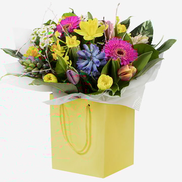 Meadow fresh a cheerful spring bouquet with daffodils hyacinths and gerberas in a yellow gift bag