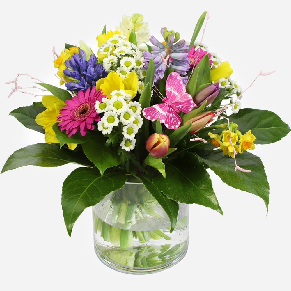 youre-wonderful-a-colourful-spring-bouquet-with-daffodils-gerberas-and-a-decorative-butterfly-in-a-glass-vase-1