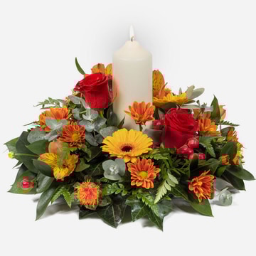 Golden diya-diwali centerpiece with red roses orange gerberas and a white candle surrounded by vibrant seasonal flowers and greenery diwali centerpiece with red roses orange gerberas and a white candle surrounded by vibrant seasonal flowers and greenery g
