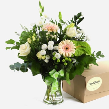 Coastal breeze pastel roses and gerberas in a vase with a ribbon