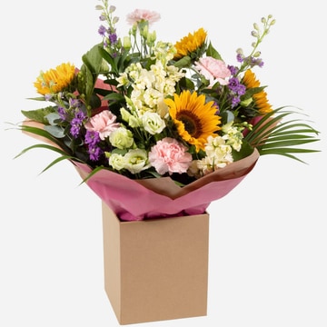Hand tied sunflower bouquet with mixed summer flowers in yellow purple and cream