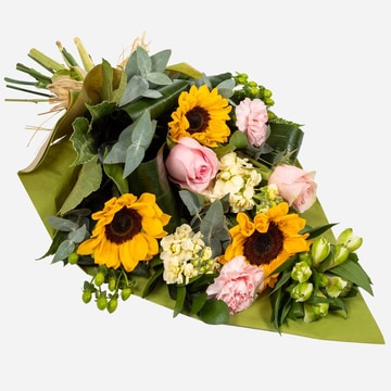 Eco friendly sunflower bouquet with pink roses and pastel flowers in kraft paper wrap