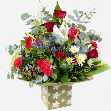 Luxury christmas bouquet in a festive star-patterned gift box