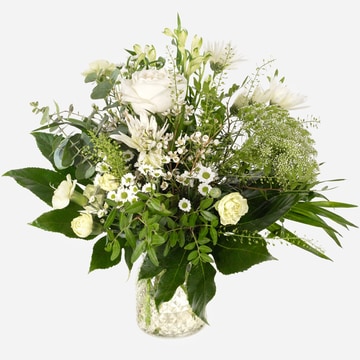 Elegant winter bouquet arranged in a clear textured glass vase elegant winter bouquet arranged in a clear textured glass vase elegant winter bouquet arranged in a clear textured glass vase