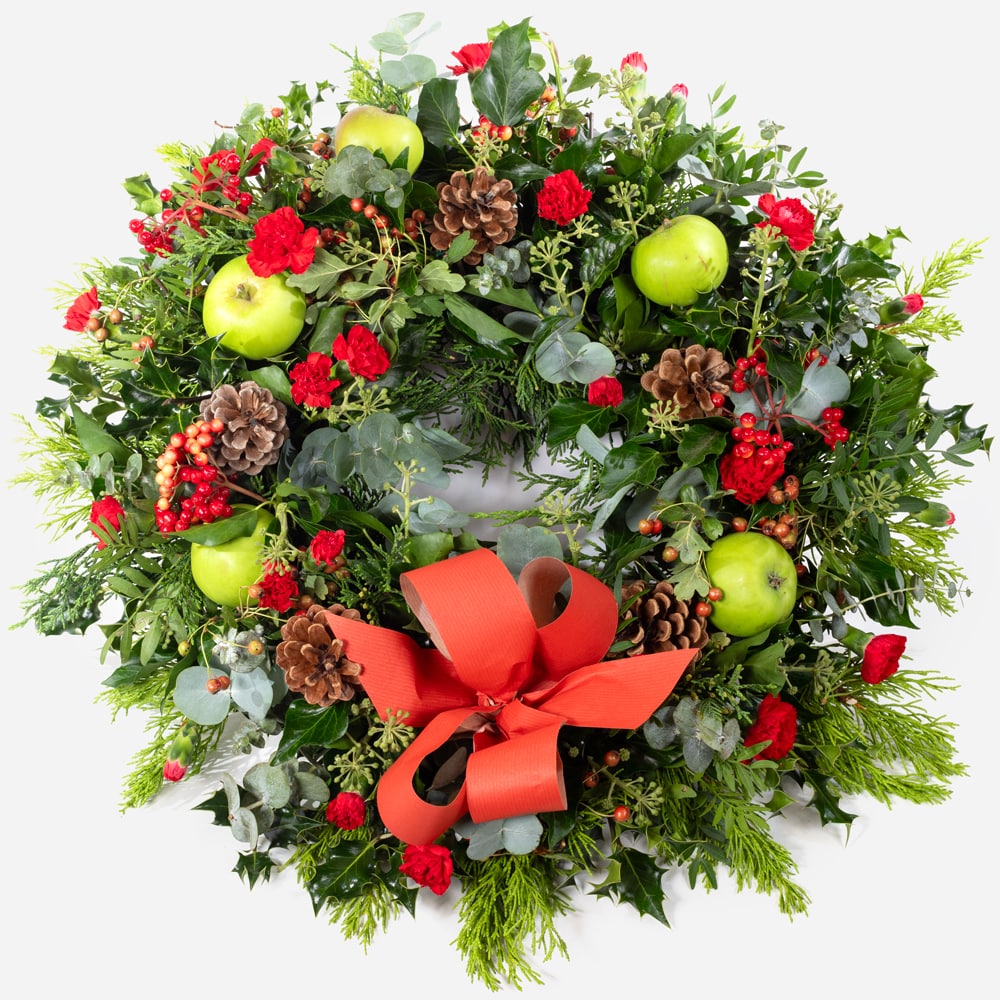 Traditional christmas wreath with festive foliage pinecones apples and a red bow traditional christmas wreath with festive foliage pinecones apples and a red bow traditional christmas wreath with festive foliage pinecones apples and a red bow