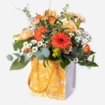 Orange and yellow flowers arranged in a jute bag and hand delivered by the local florist orange and yellow flowers arranged in a jute bag and hand delivered by the local florist orange and yellow flowers arranged in a jute bag and hand delivered by the lo