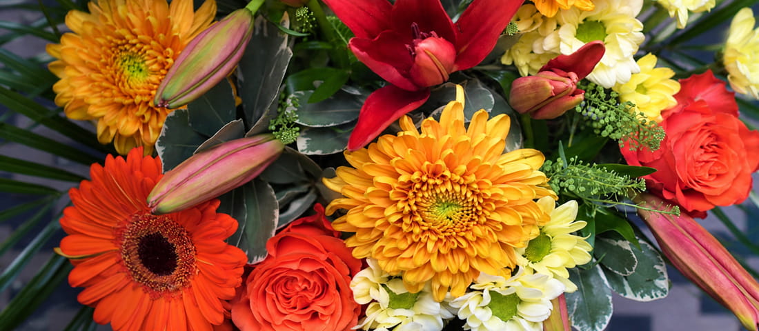 Florist wrapping a seasonal bouquet in kraft paper