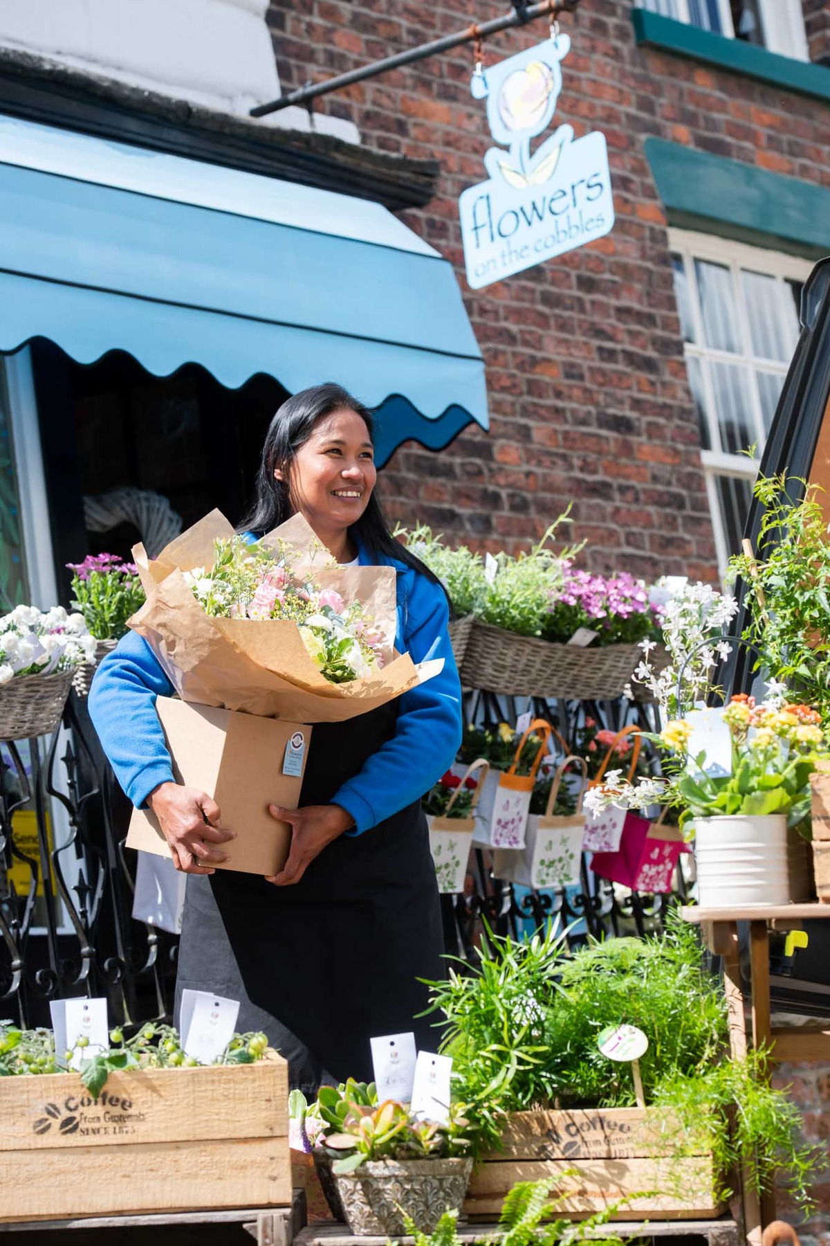 Florist taking flowers outside shop for delivery in Ireland