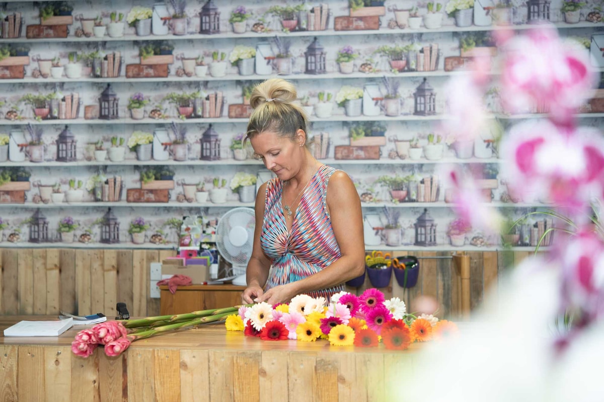 Skilled florist working with precision in bright flower shop