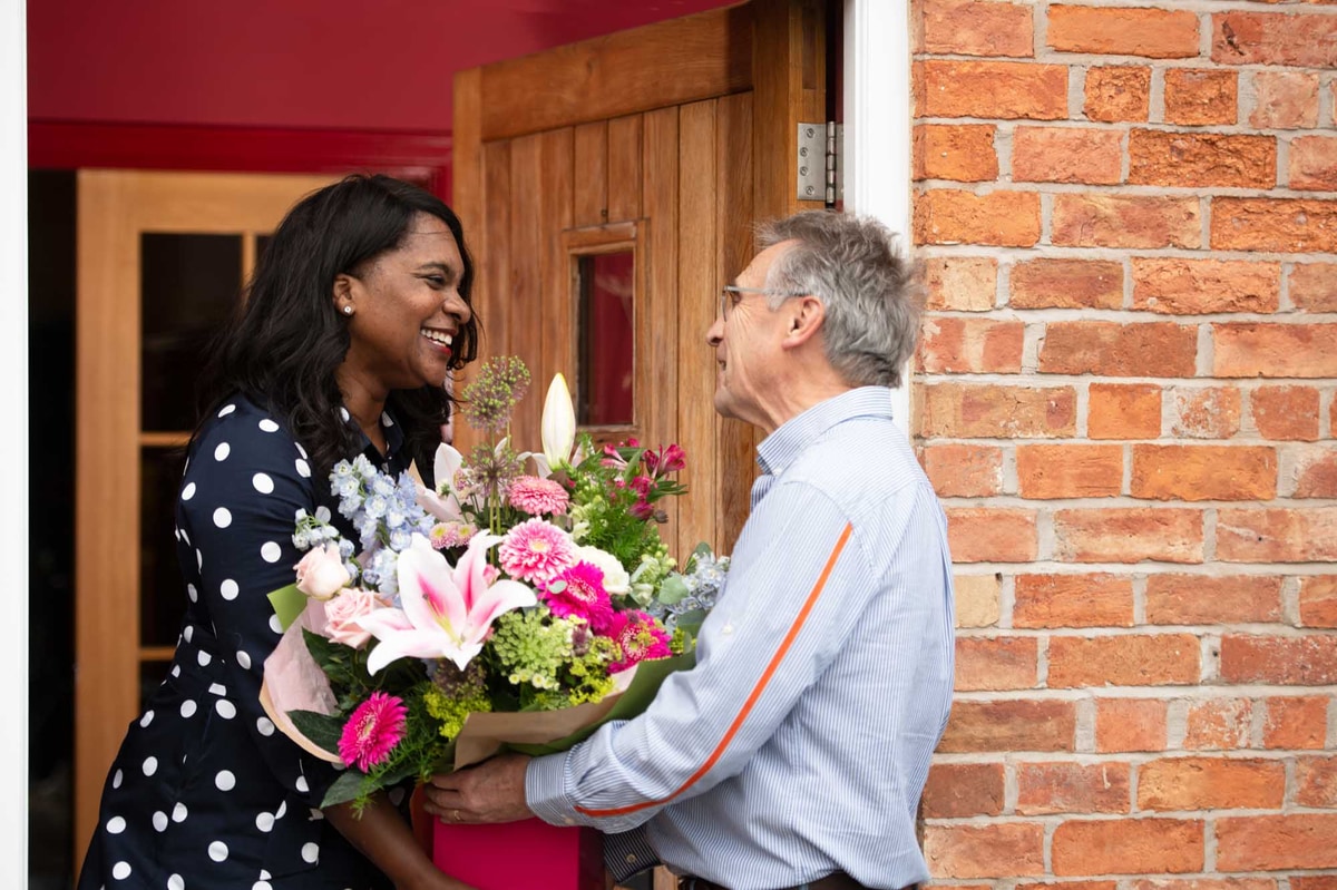 Florist delivery man delivers large bouquet of flowers