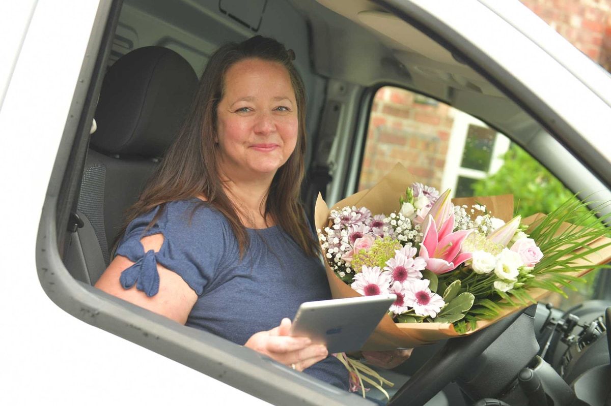Florist sitting in a delivery van about to deliver fresh flowers with same day flower delivery service