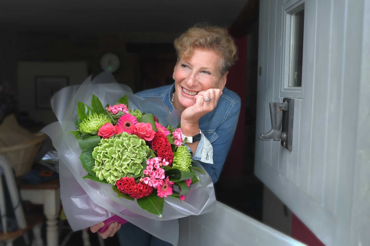 Customer receiving seasonal summer bouquet from local florist